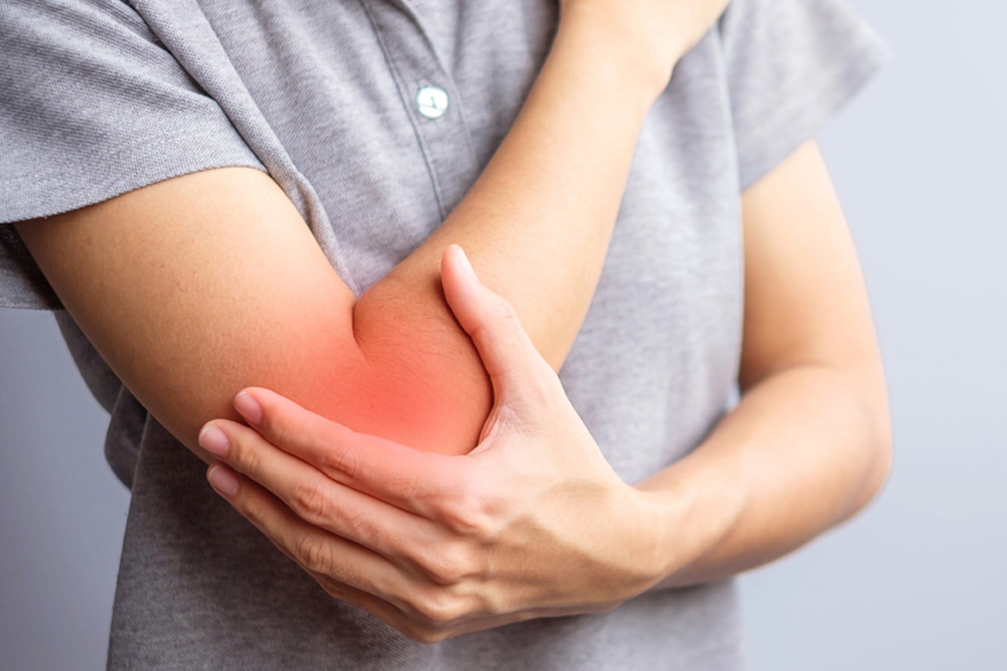 adult female with her muscle pain on gray background. Woman havi
