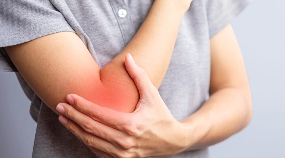adult female with her muscle pain on gray background. Woman havi